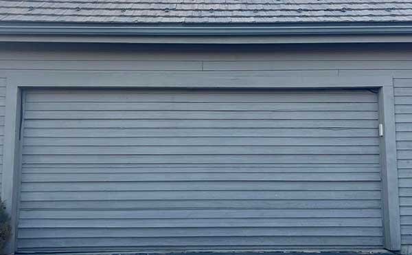 Closed gray garage door on vintage building
