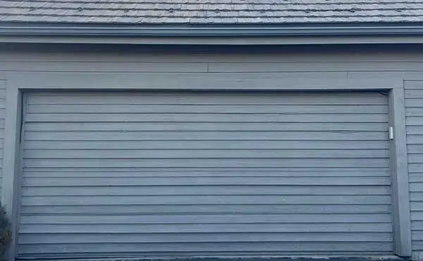 Closed gray garage door on vintage building