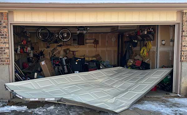Collapsed garage door with clutter inside