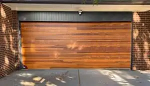 Modern wooden garage door with brick walls