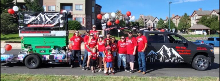 Group with truck and trailer, balloons in background.