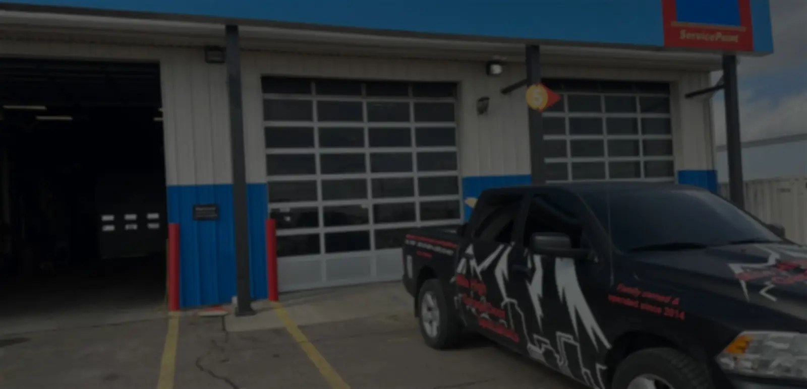 Service garage with branded truck parked outside