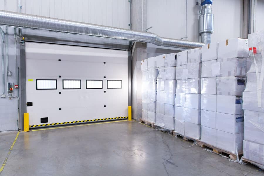 Warehouse loading dock with stacked pallets.