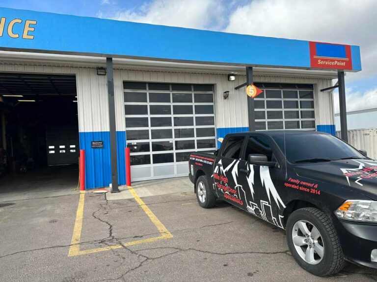 Garage service center with parked company truck.