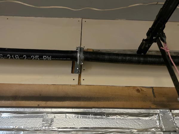 Garage door tension spring and assembly
