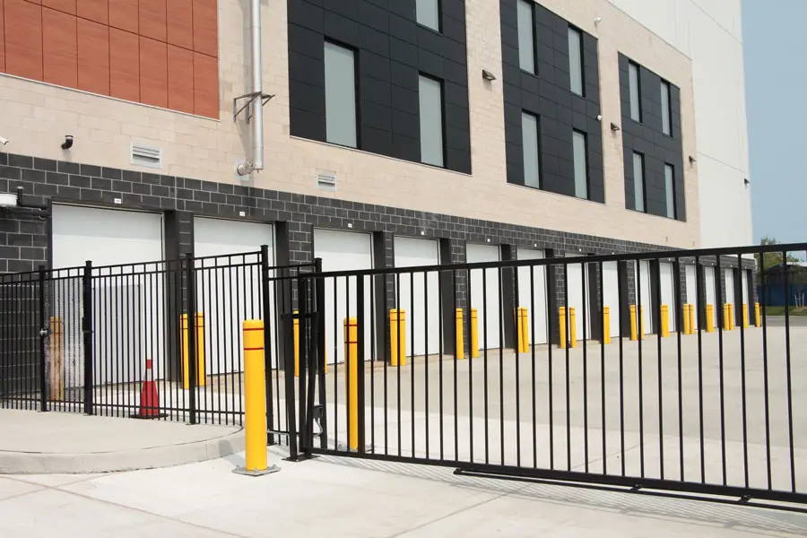 Modern industrial building with gated parking bays.
