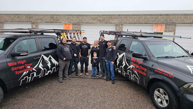 Mile High Garage Door team with trucks in background.