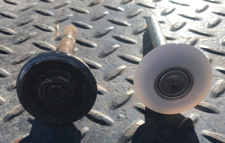 Old versus new caster wheel on metal floor.