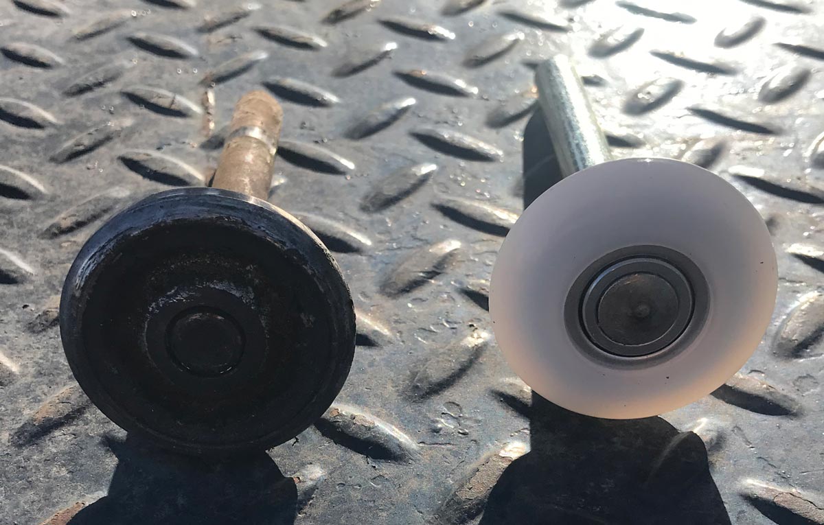 Old versus new caster wheel on metal floor.